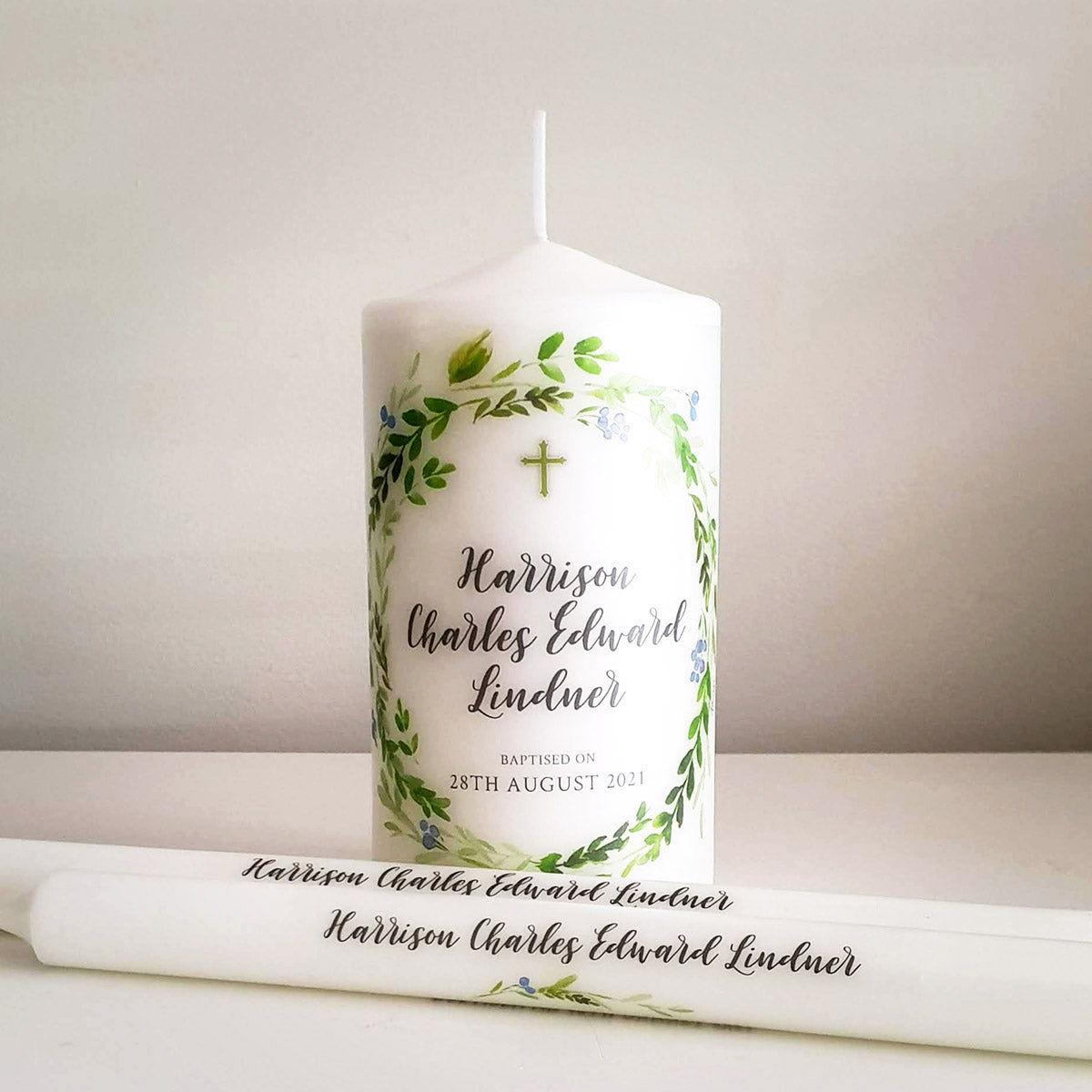 Small Baptism candle with leafy wreath and black lettering with 2 personalised taper candles