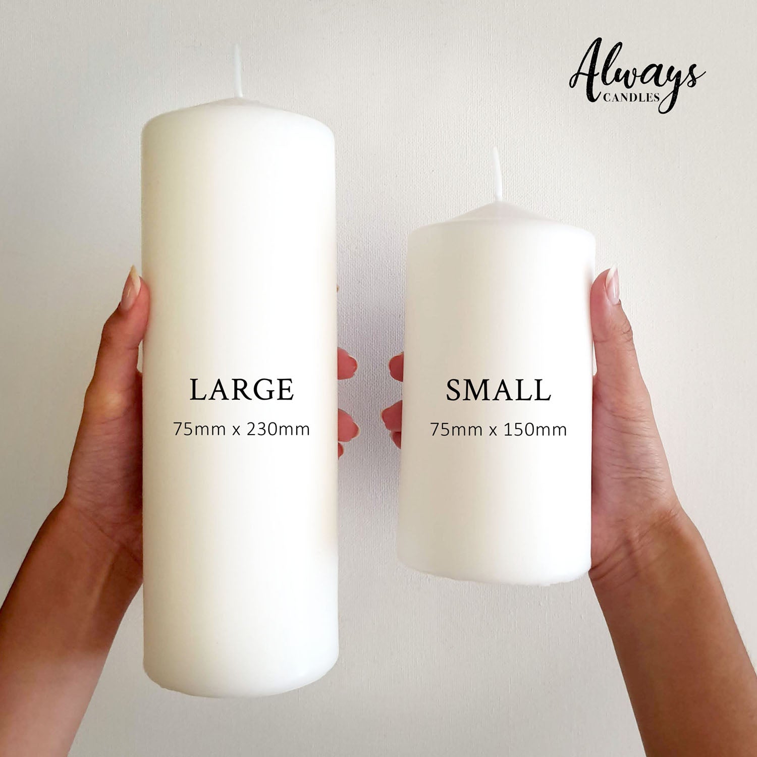 Two hands holding a large white pillar candle and a small white pillar candle
